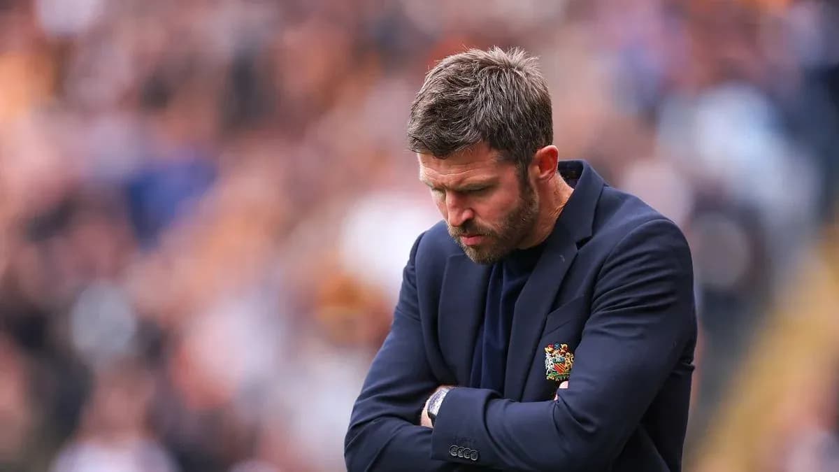 Coach with arms crossed during match on sidelines Coach with arms crossed during match on sidelines