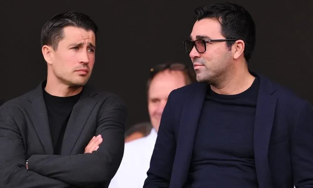 Two men discussing in a sports venue Two men discussing in a sports venue