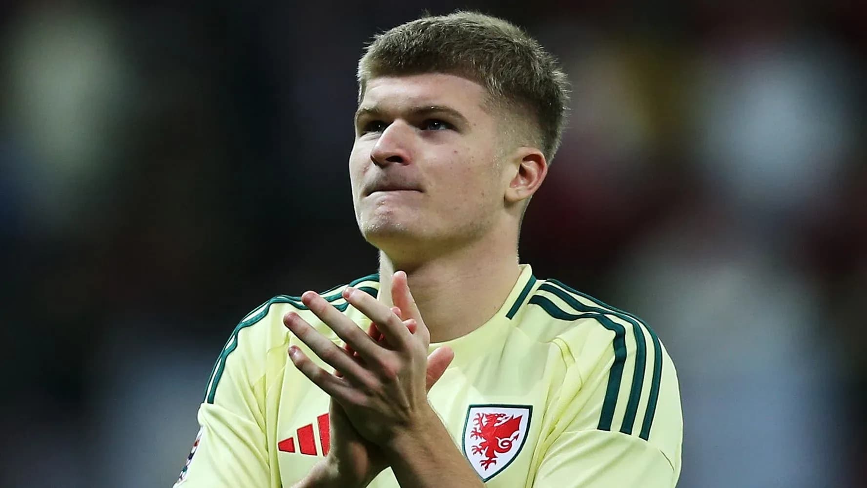 Player applauding fans after match wearing yellow kit Player applauding fans after match wearing yellow kit