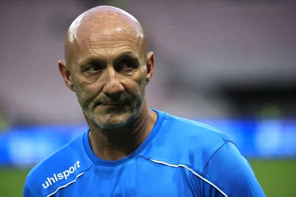 Coach in blue training kit on the field Coach in blue training kit on the field