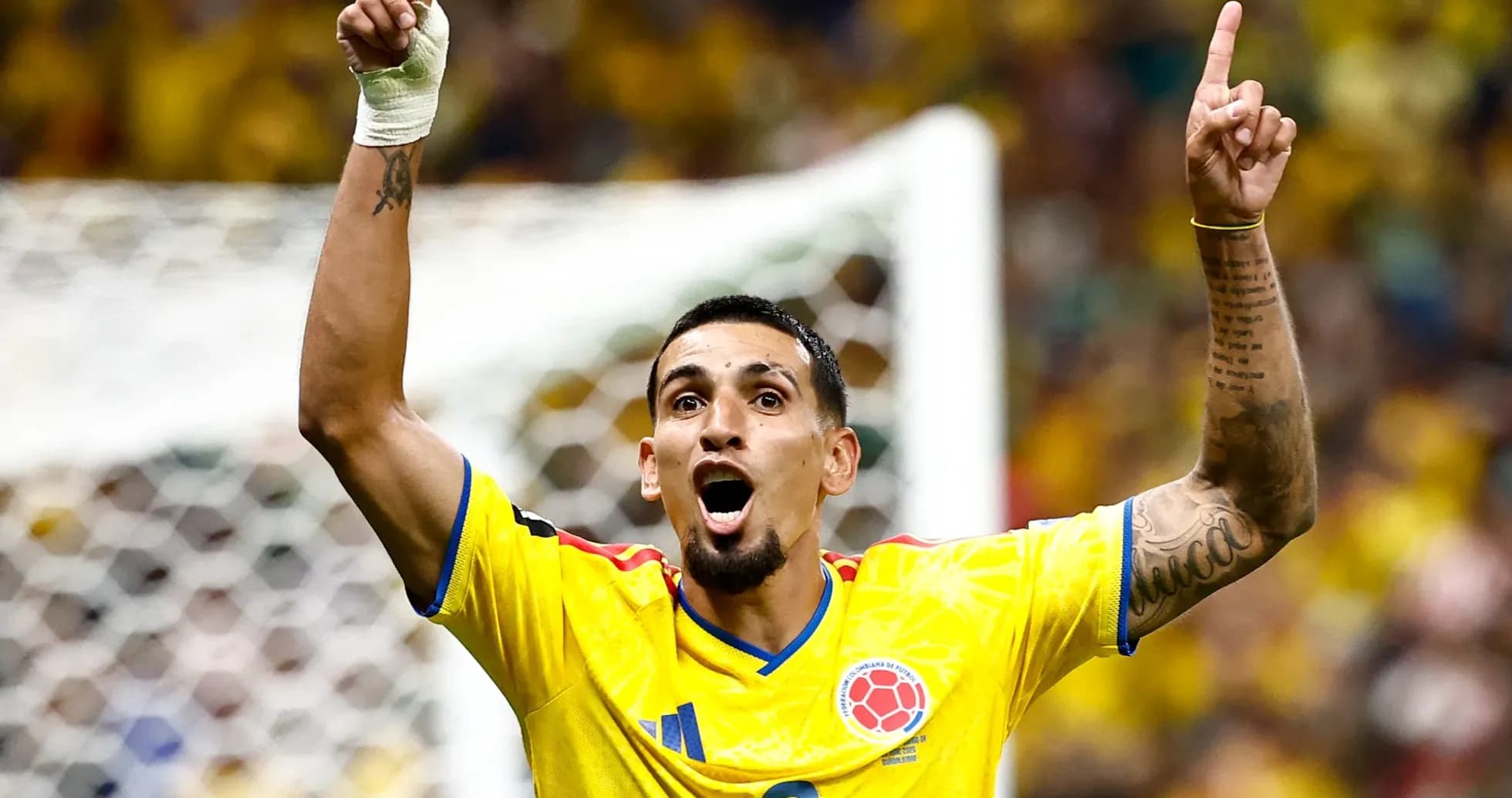 Player celebrating with raised arms in yellow jersey Player celebrating with raised arms in yellow jersey