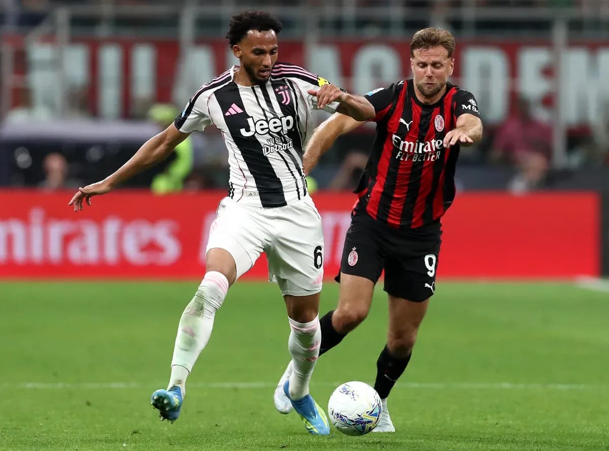 Juventus player battling with AC Milan opponent Juventus player battling with AC Milan opponent