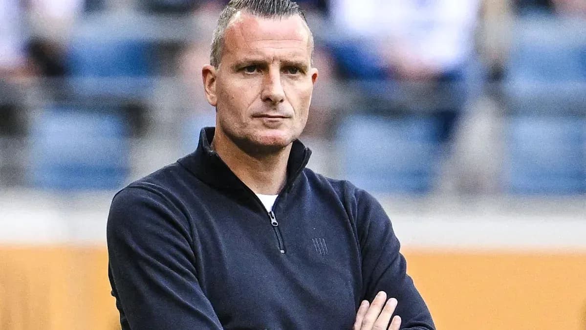 Coach standing with arms crossed during match Coach standing with arms crossed during match