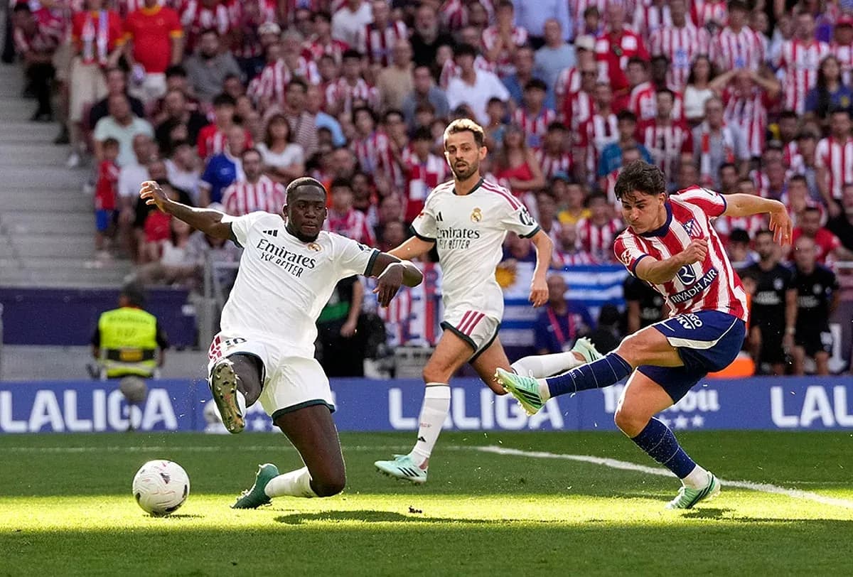 Atletico player kicking ball against Real Madrid Atletico player kicking ball against Real Madrid