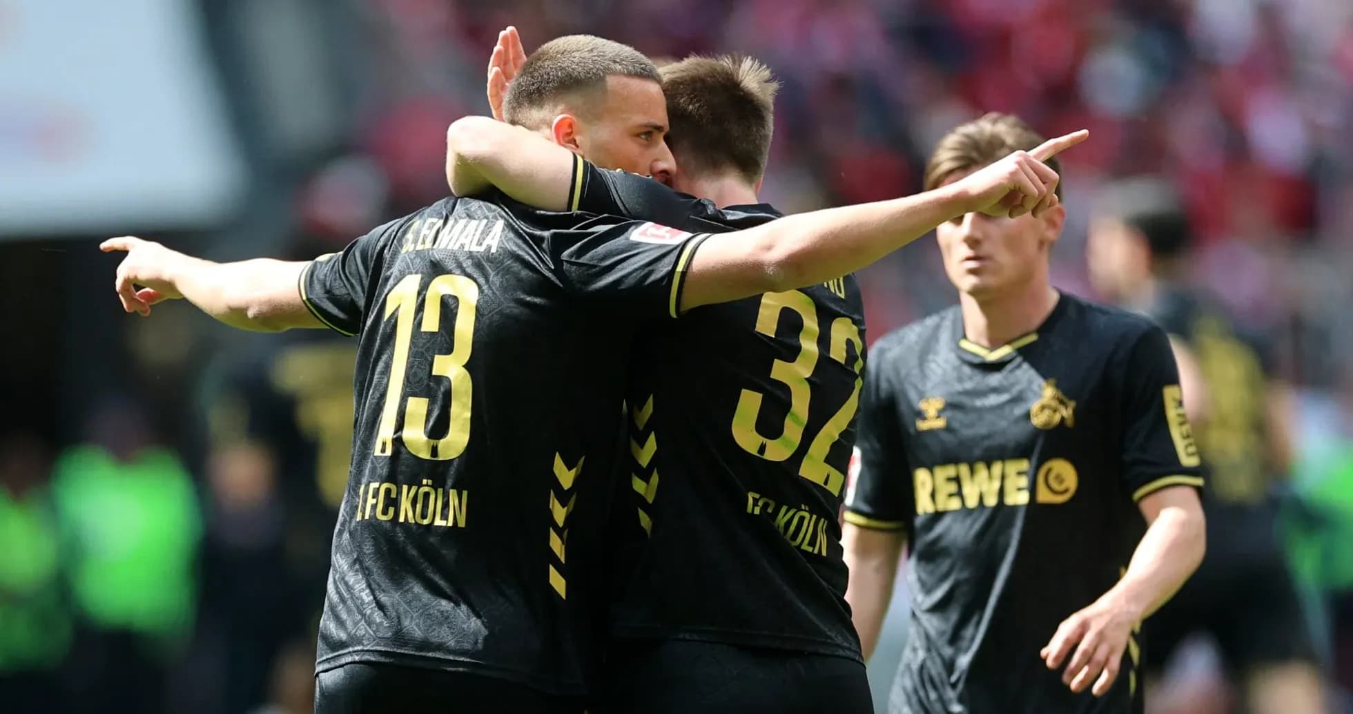 FC Köln players celebrating a goal on the pitch FC Köln players celebrating a goal on the pitch
