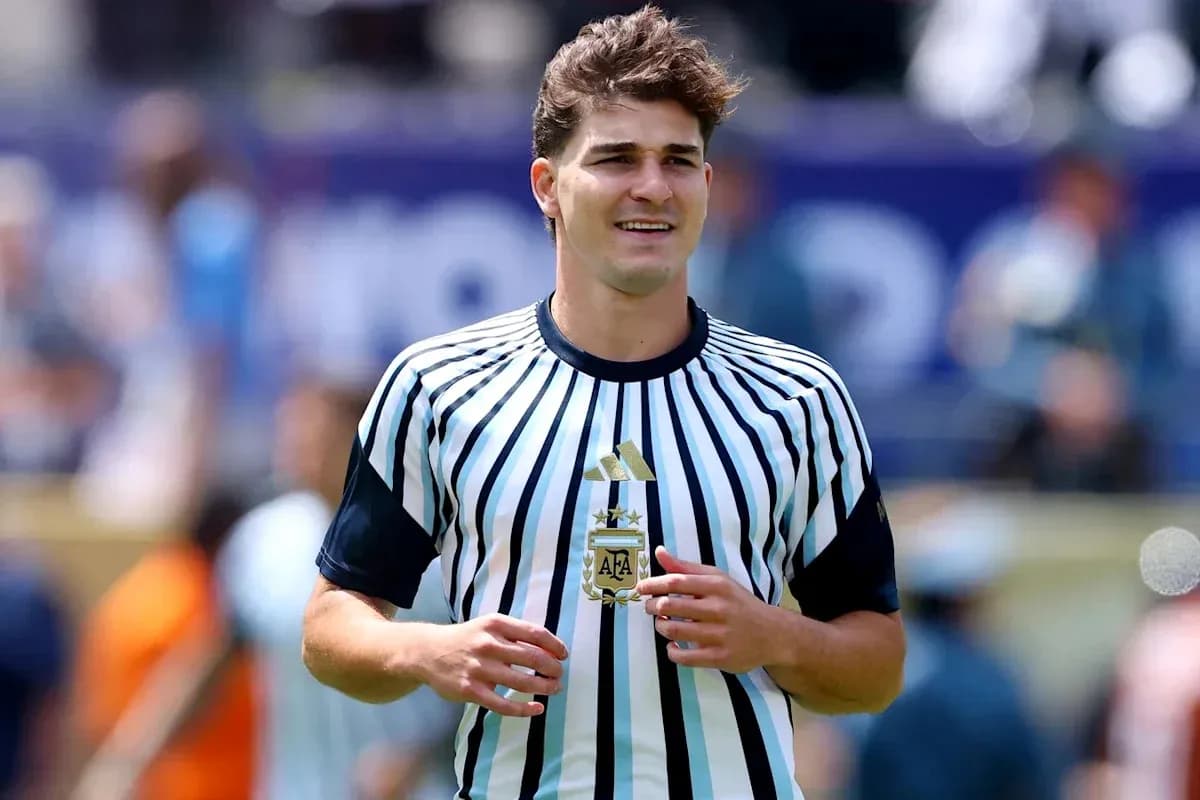 Player in striped jersey holding trophy on field Player in striped jersey holding trophy on field