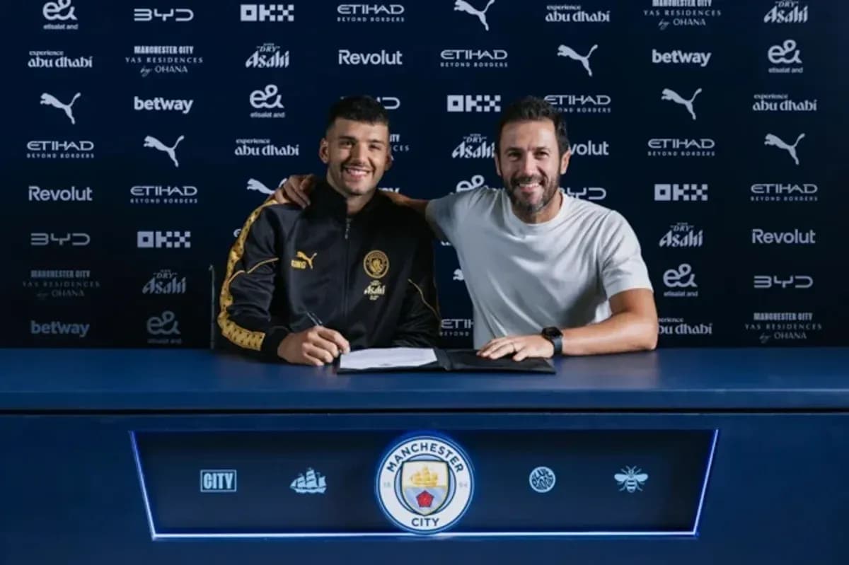 Player signing contract with manager at press table Player signing contract with manager at press table