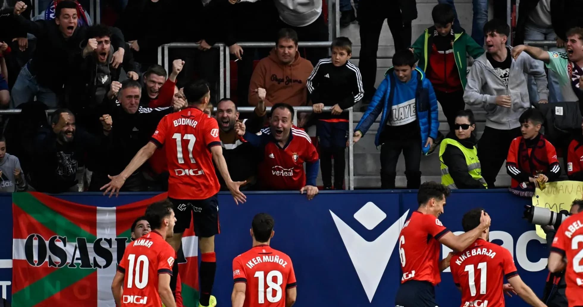 Osasuna players celebrating with fans after a goal Osasuna players celebrating with fans after a goal