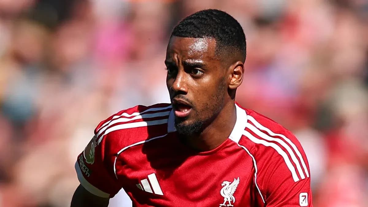 Player in Liverpool jersey running on the field Player in Liverpool jersey running on the field