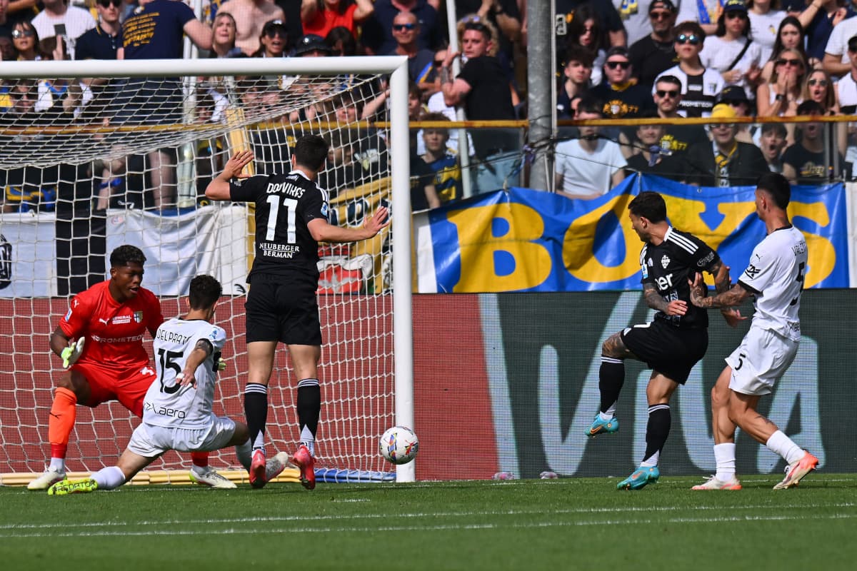 Como and Parma players competing near the goal Como and Parma players competing near the goal