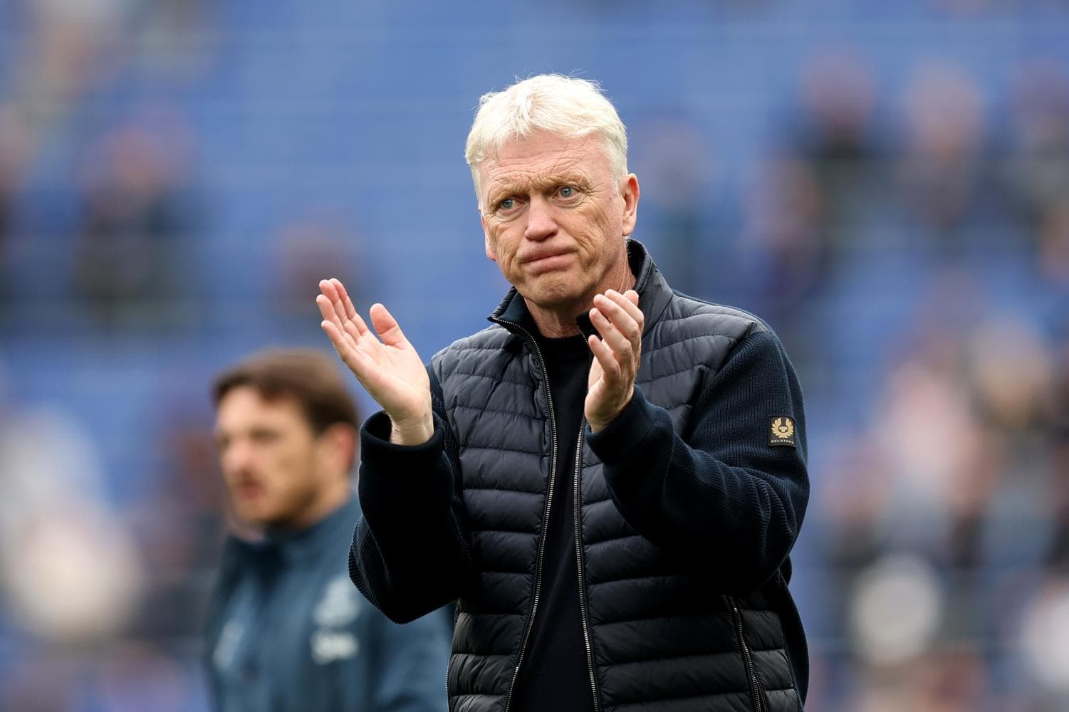 Manager clapping during match on the sidelines Manager clapping during match on the sidelines