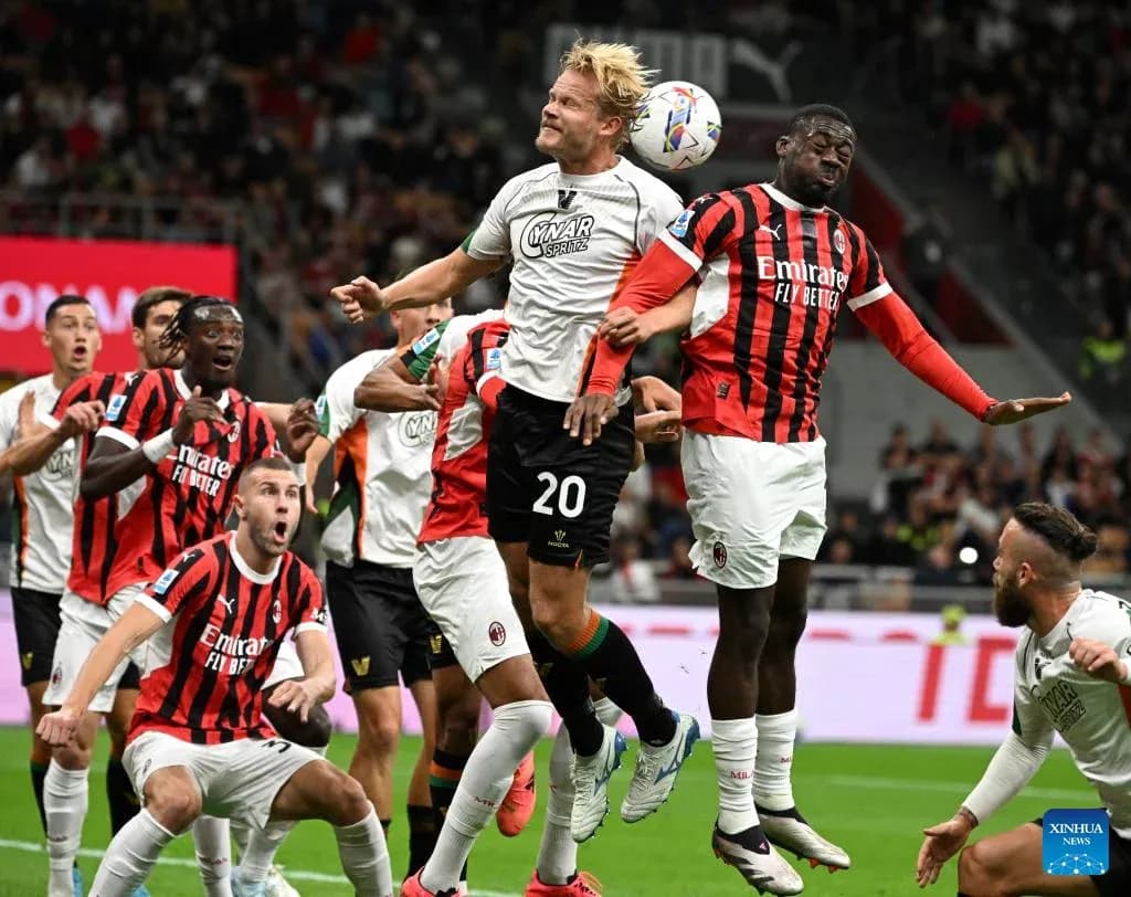 Players competing for the ball during AC Milan match Players competing for the ball during AC Milan match
