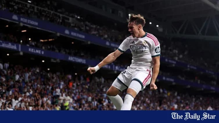 Player celebrating a goal in stadium crowd Player celebrating a goal in stadium crowd