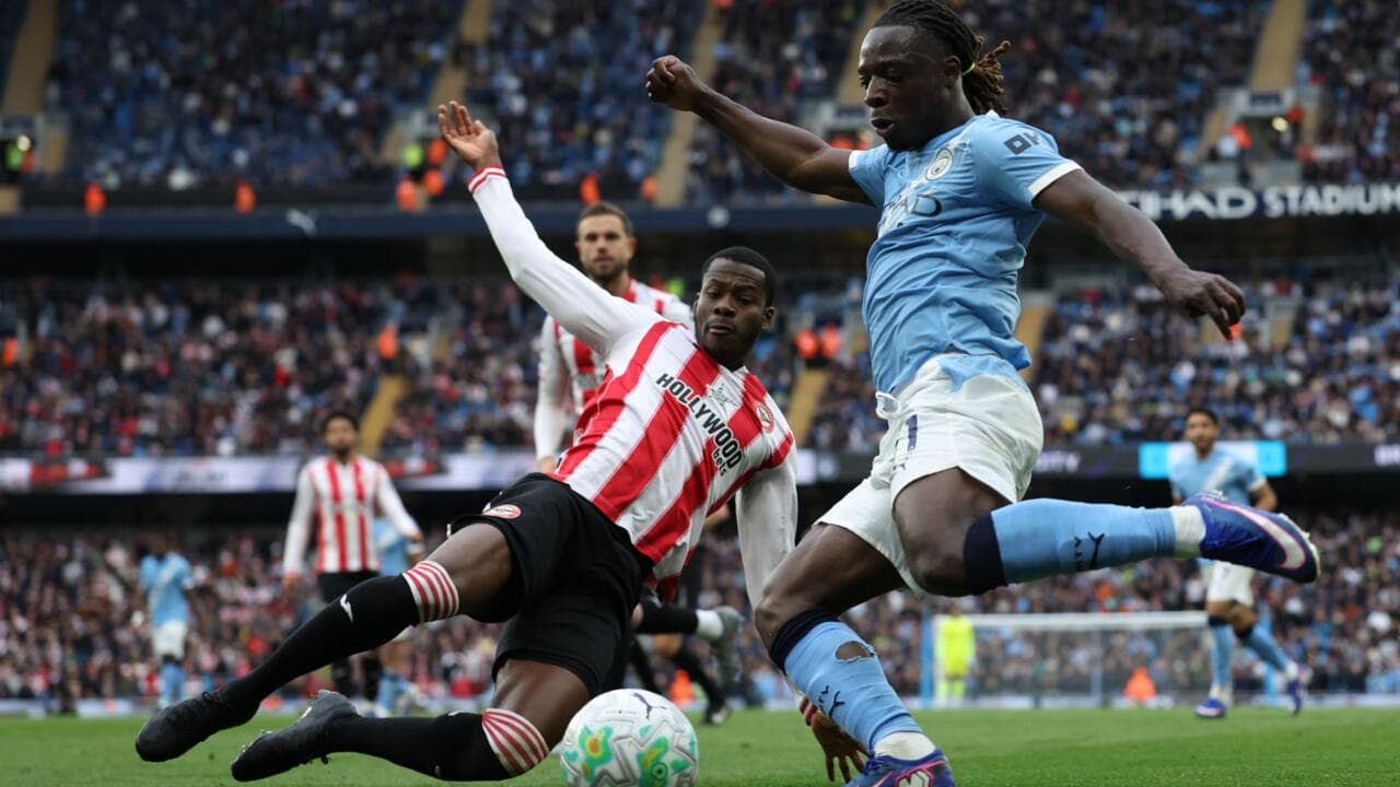 Player tackling opponent during a football match Player tackling opponent during a football match