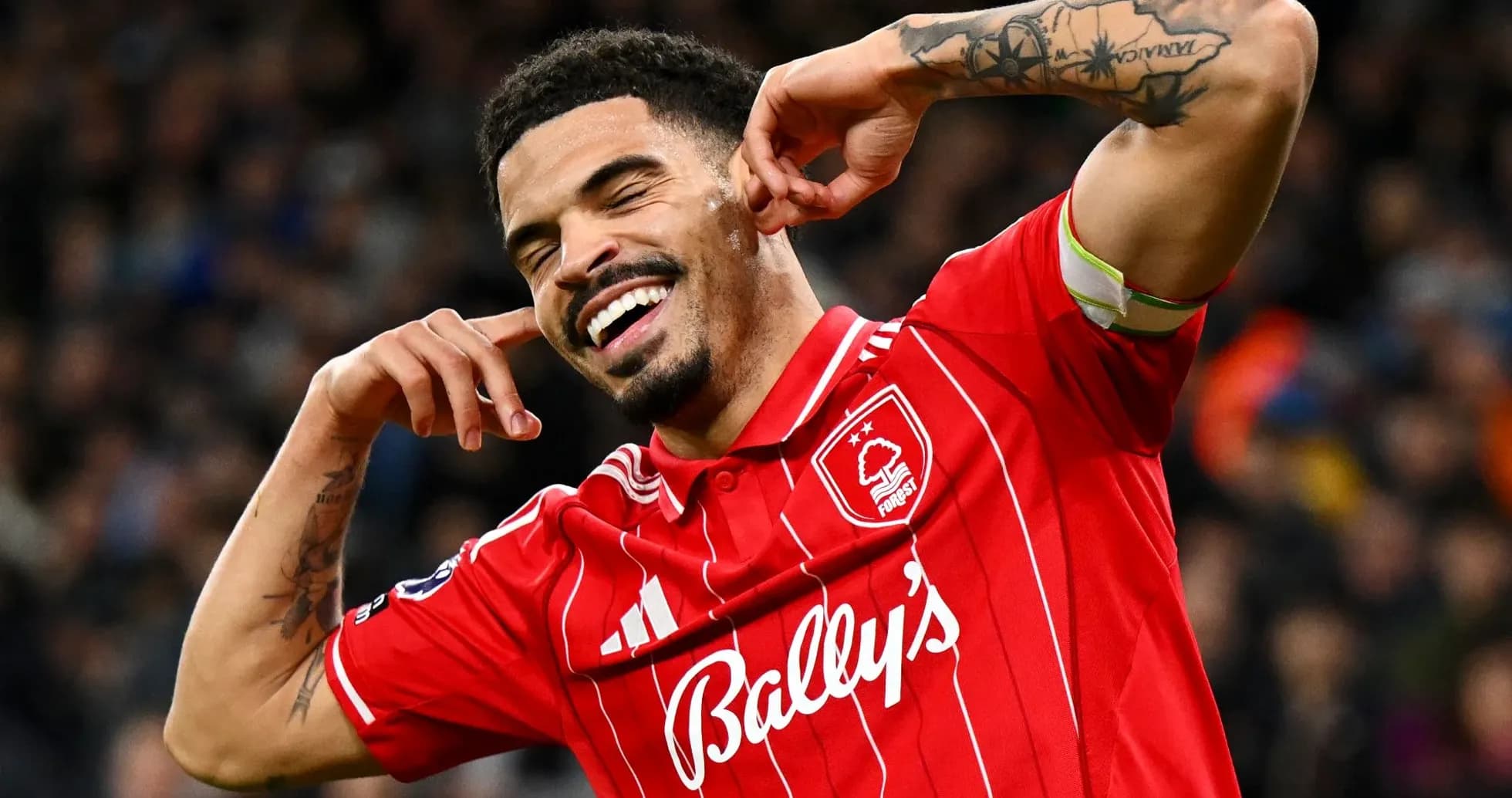 Player celebrating a goal with hands by ears Player celebrating a goal with hands by ears