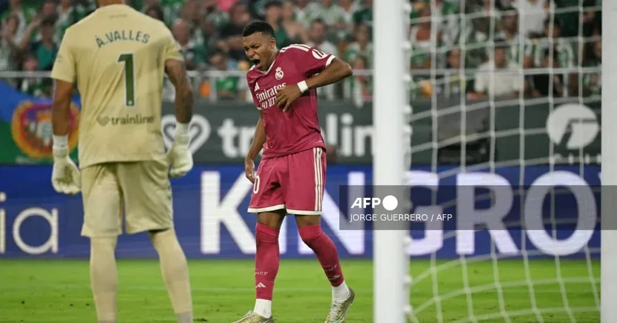 Player celebrating a goal with goalkeeper in background Player celebrating a goal with goalkeeper in background