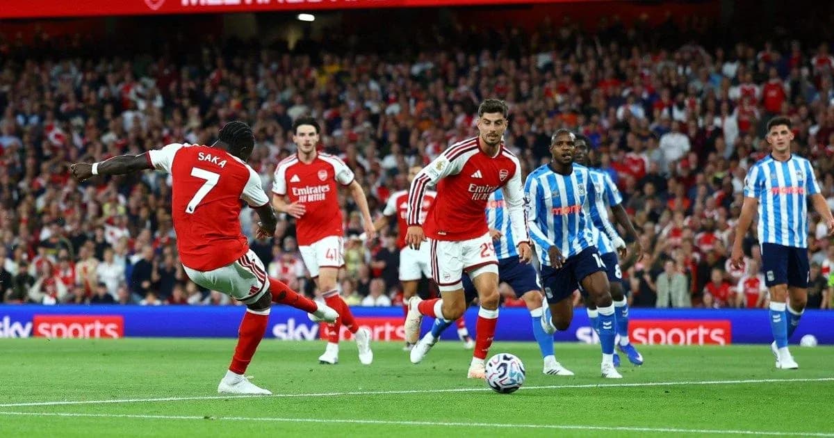 Arsenal player Saka dribbling during match against Brighton Arsenal player Saka dribbling during match against Brighton