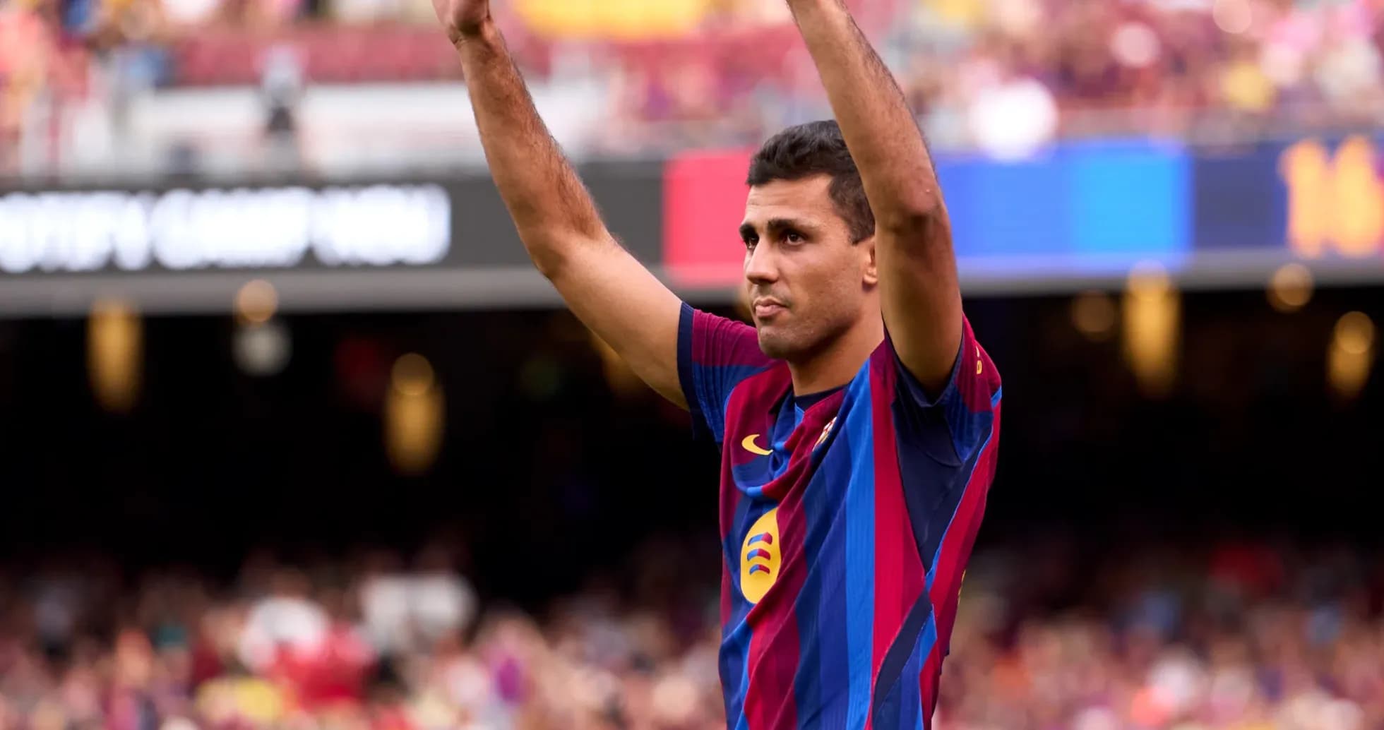 Player raising hands in celebration at Camp Nou Player raising hands in celebration at Camp Nou