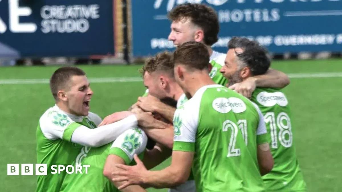 Players celebrating a goal on the pitch Players celebrating a goal on the pitch