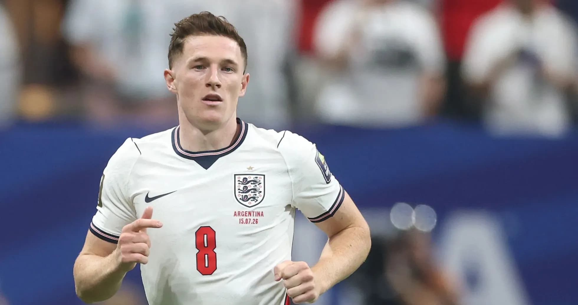 Player wearing England kit running on the pitch Player wearing England kit running on the pitch