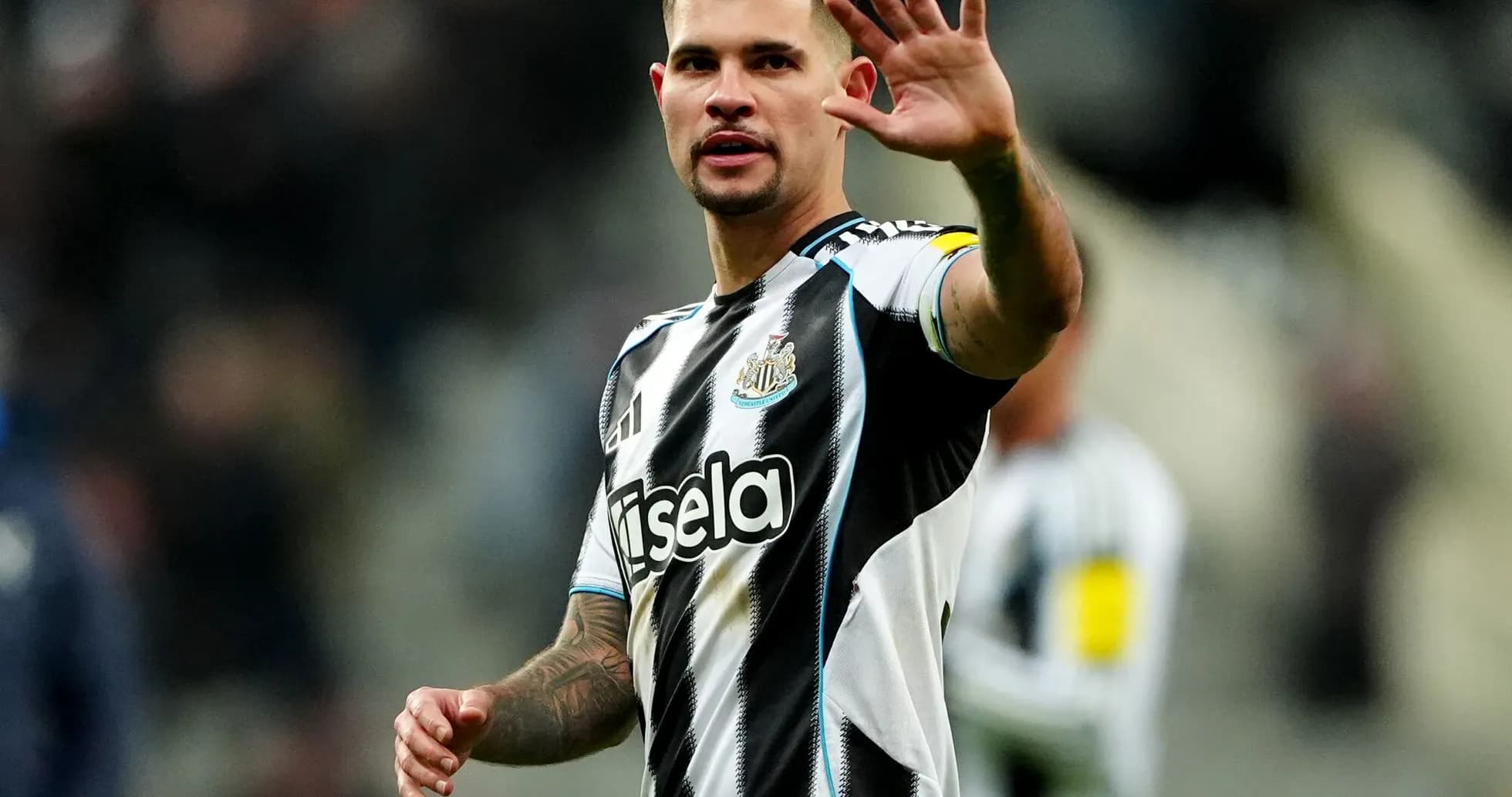 Player waving while wearing Newcastle United jersey Player waving while wearing Newcastle United jersey