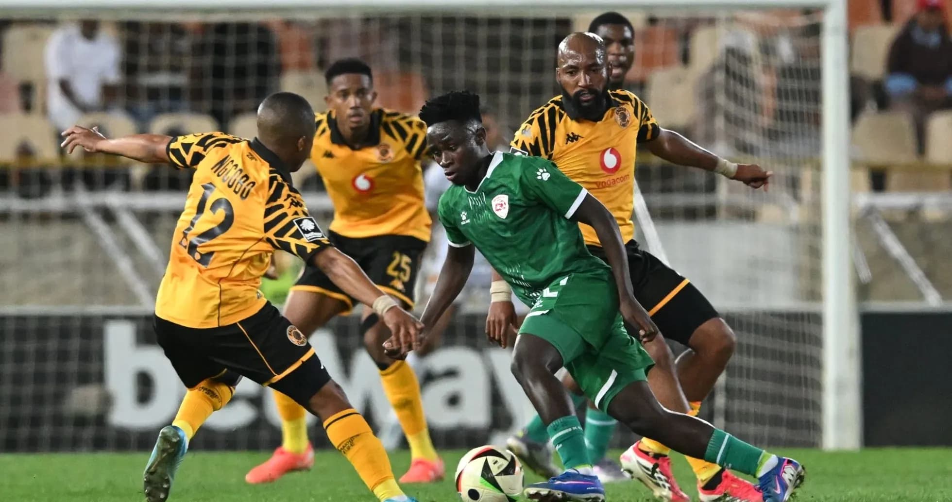 Players competing for the ball during a soccer match Players competing for the ball during a soccer match