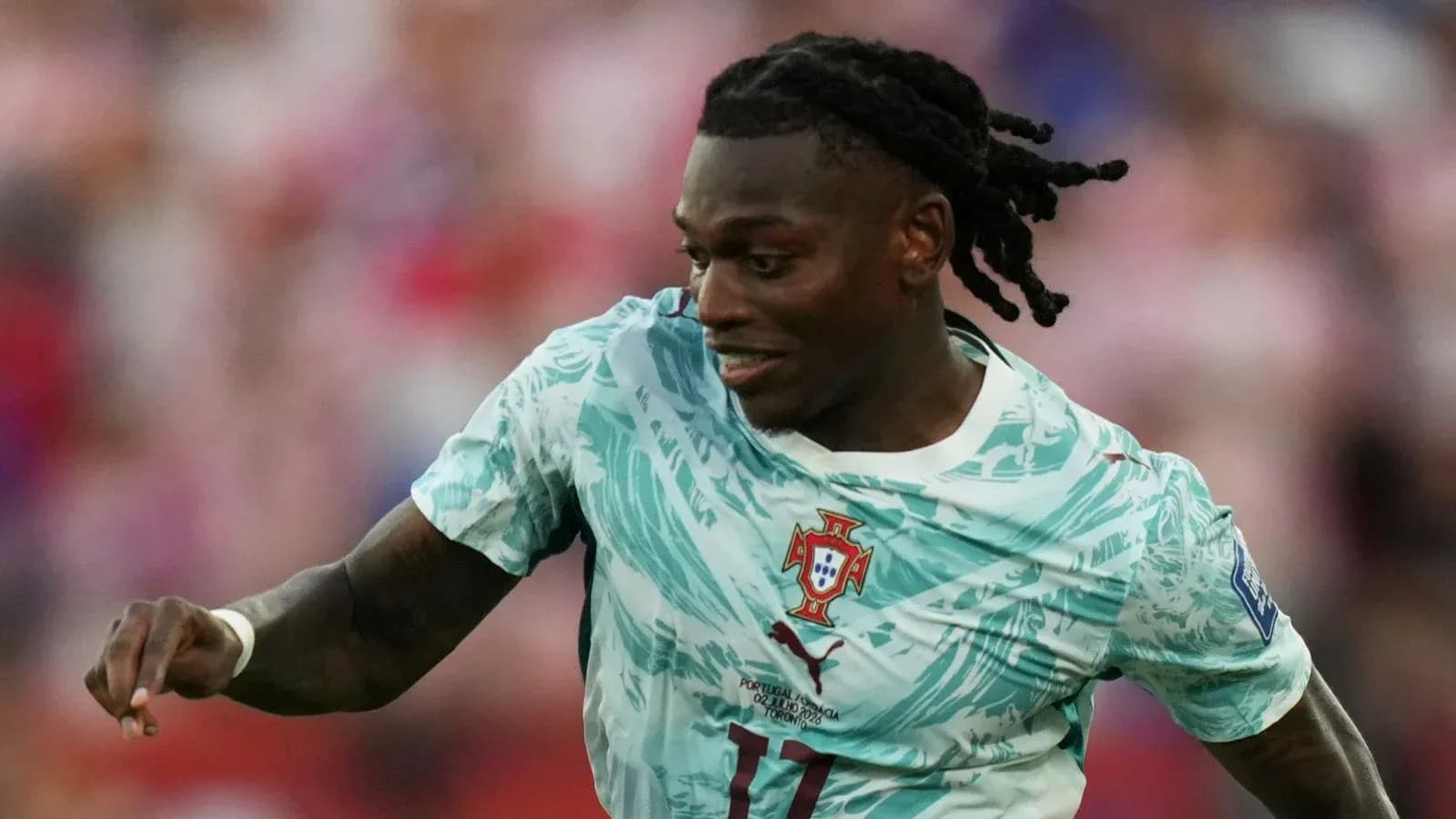 Player in Portugal kit running on the field Player in Portugal kit running on the field