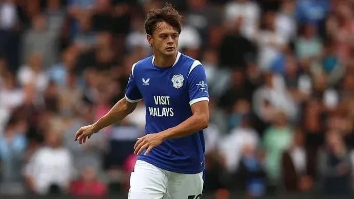 Player running on field in blue Cardiff City kit Player running on field in blue Cardiff City kit