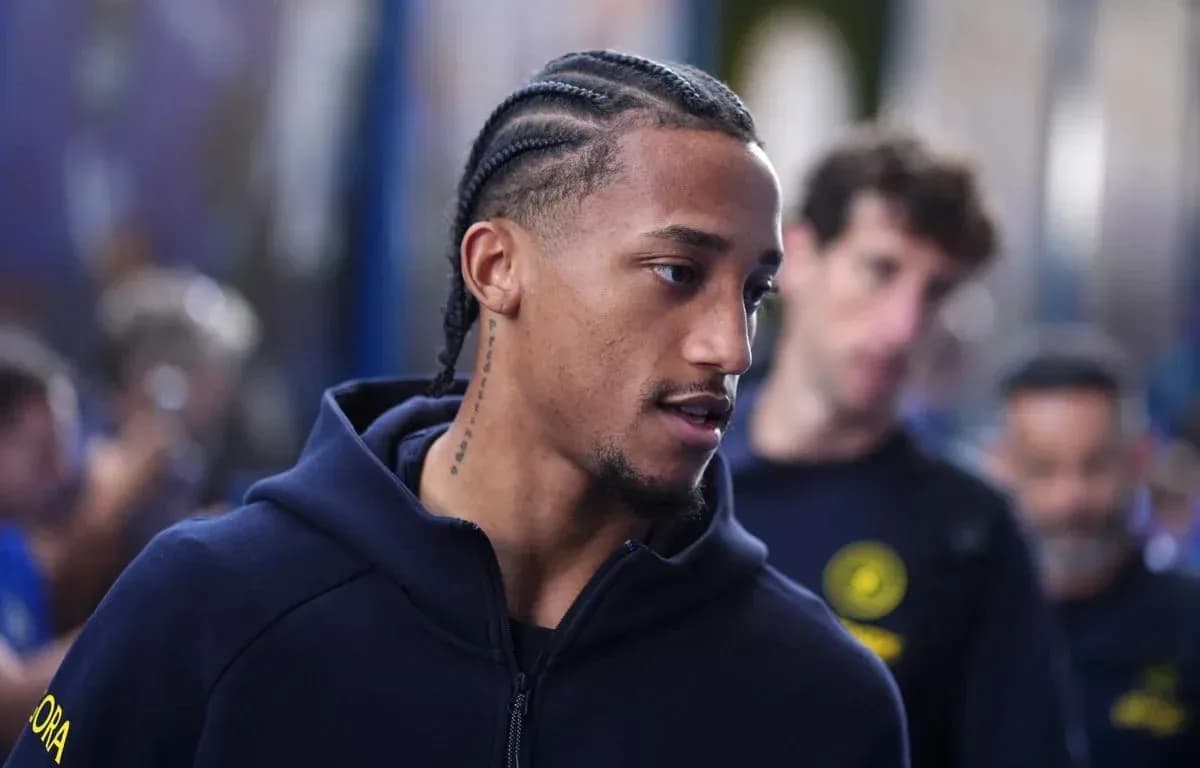 Player with braids walking through team area Player with braids walking through team area