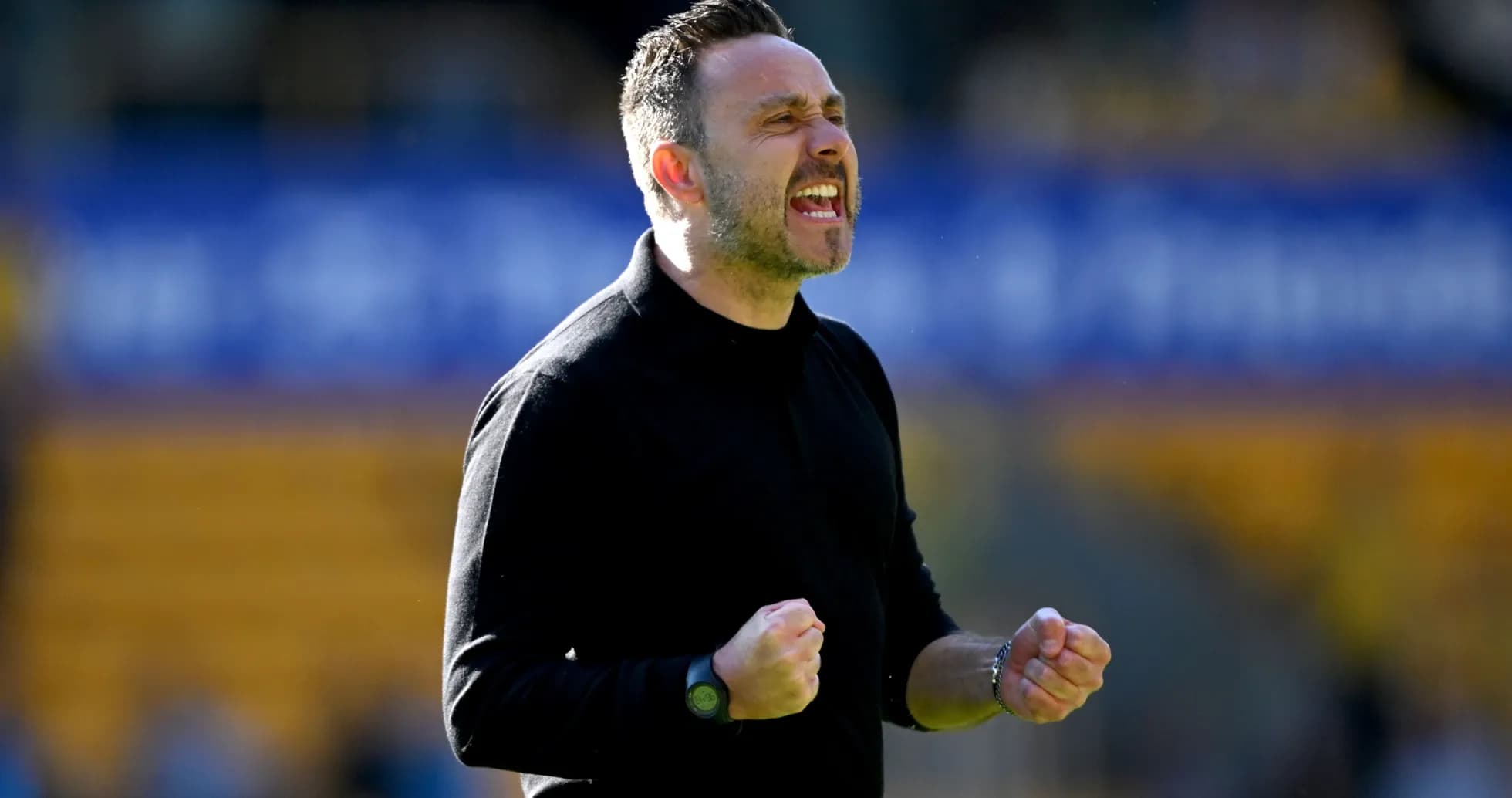 Coach celebrating with clenched fists during match Coach celebrating with clenched fists during match