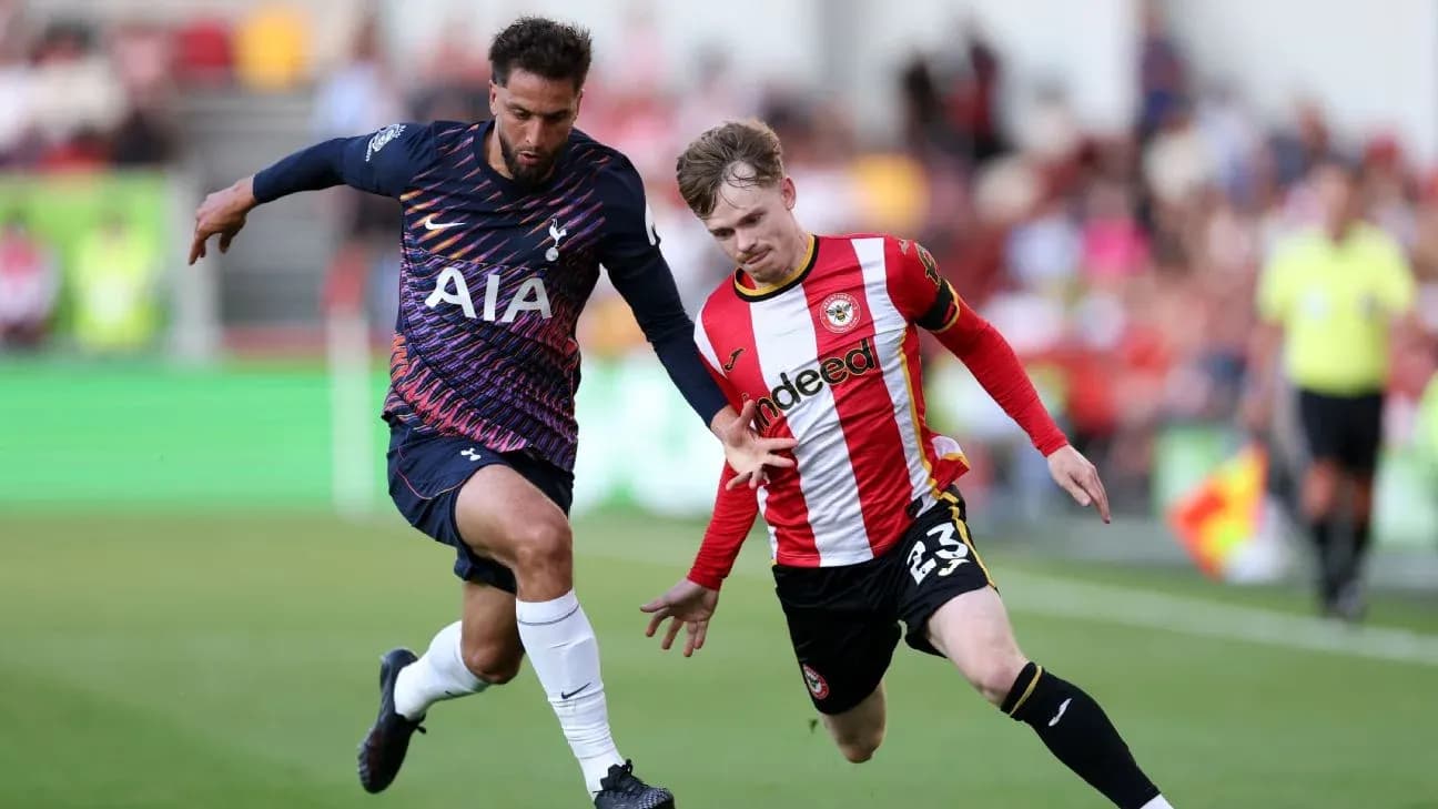 Brentford player challenging Tottenham player for the ball Brentford player challenging Tottenham player for the ball