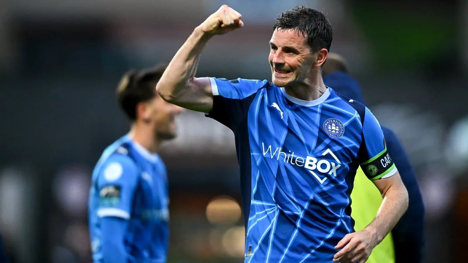 Player celebrating victory with raised fist Player celebrating victory with raised fist