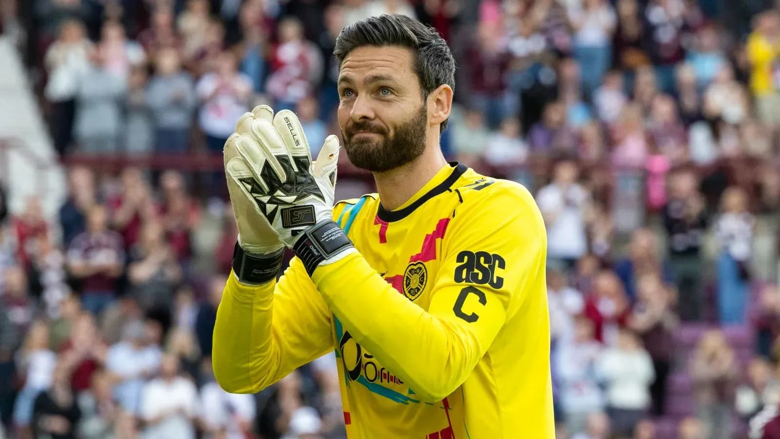 Goalkeeper applauding fans during match celebration Goalkeeper applauding fans during match celebration