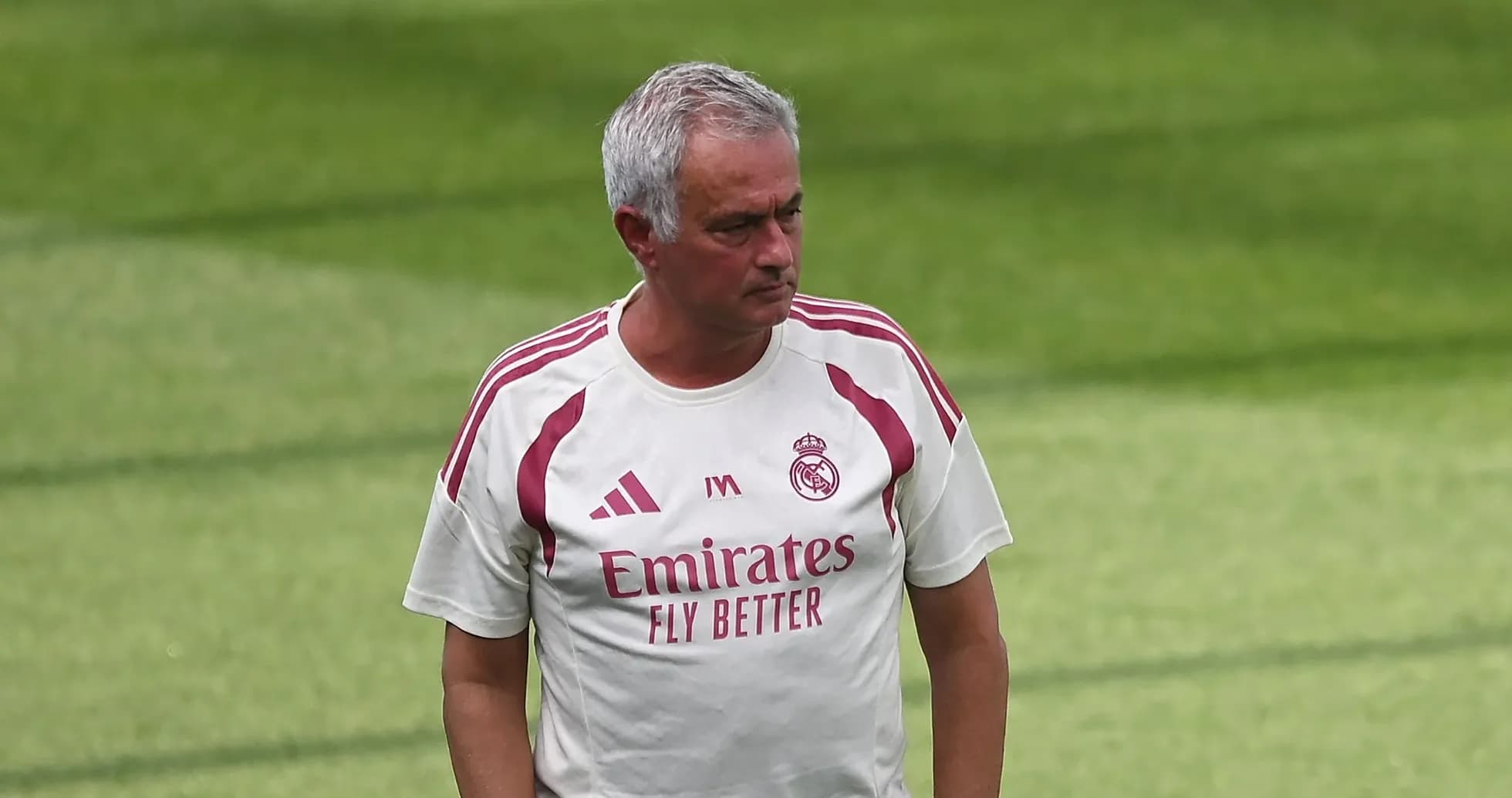 Coach walking on training pitch wearing team kit Coach walking on training pitch wearing team kit