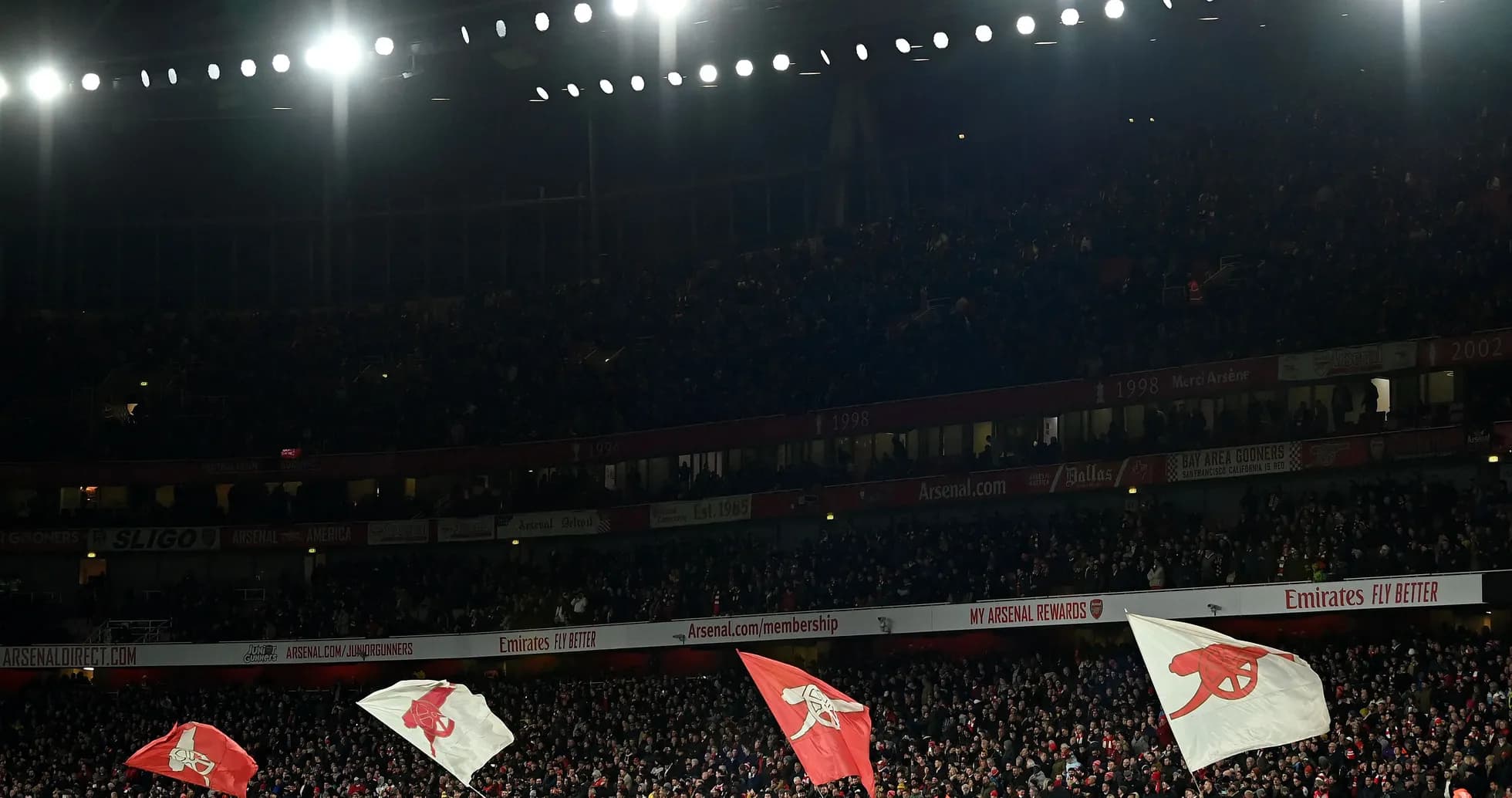 Fans waving flags in a packed stadium Fans waving flags in a packed stadium