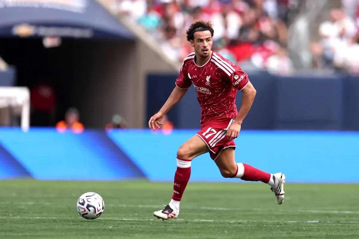 Player in red Liverpool kit running with ball Player in red Liverpool kit running with ball