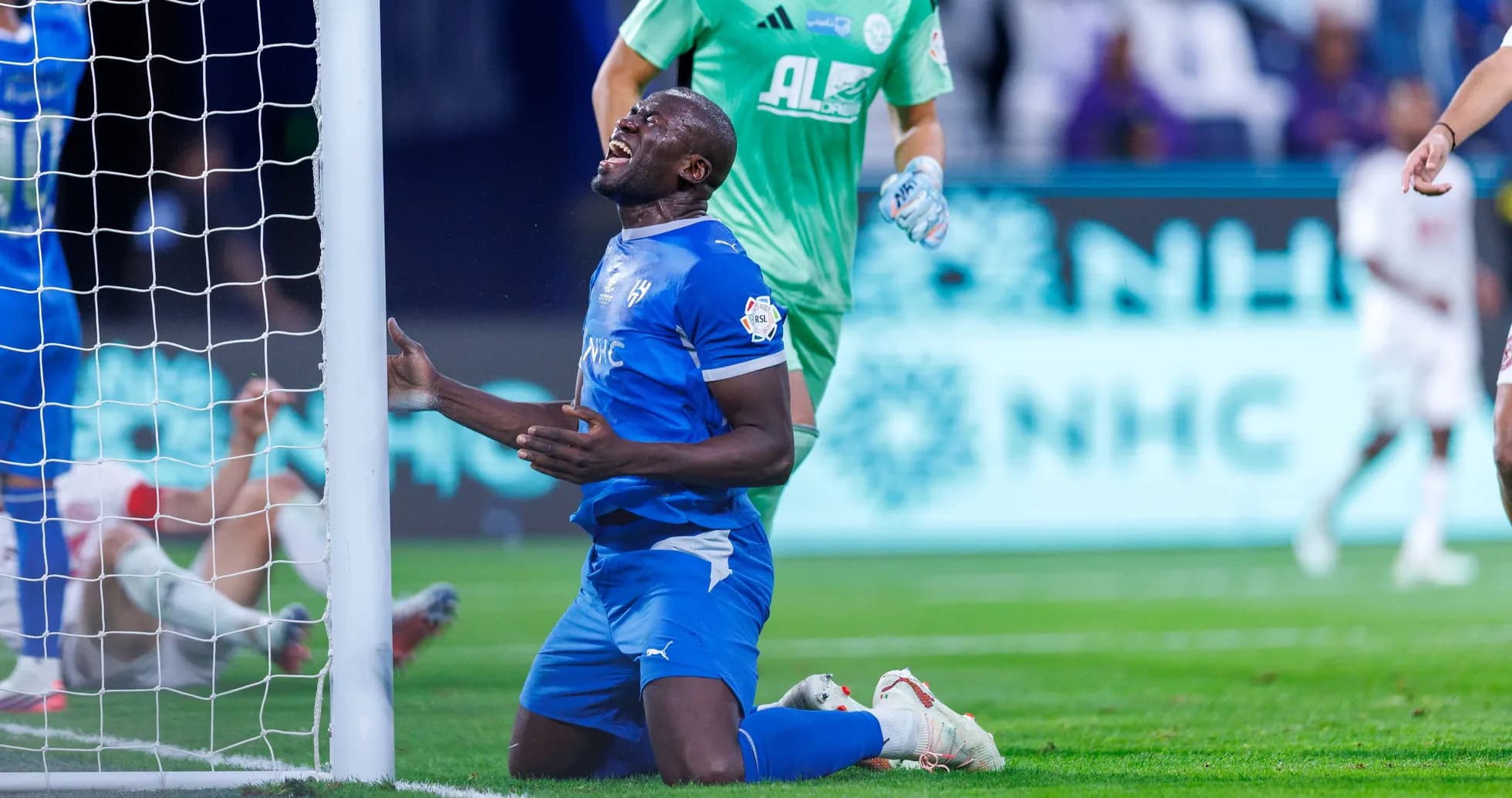 Player kneeling near goal post after a missed chance Player kneeling near goal post after a missed chance