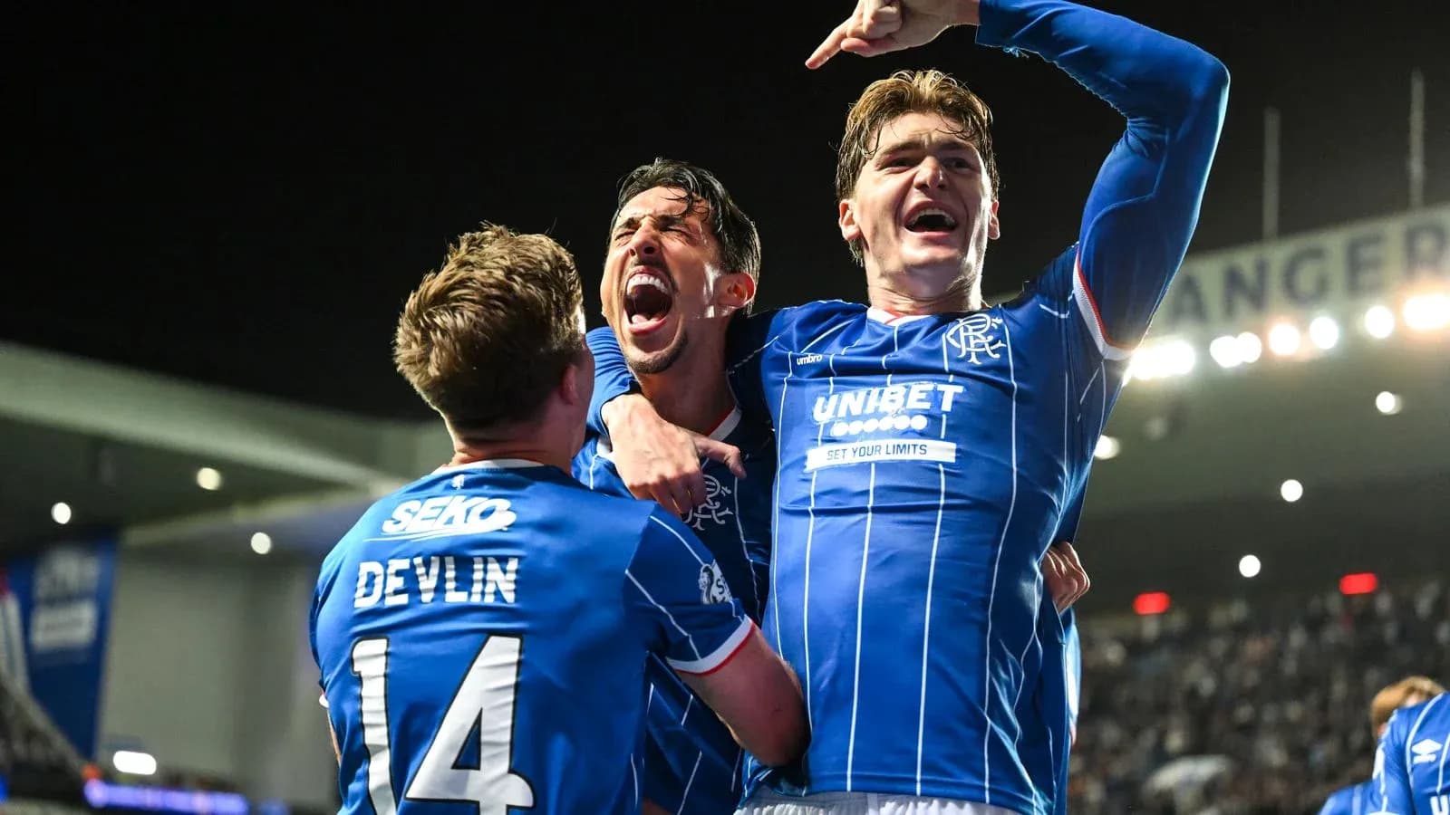 Rangers players celebrating a goal in blue jerseys Rangers players celebrating a goal in blue jerseys