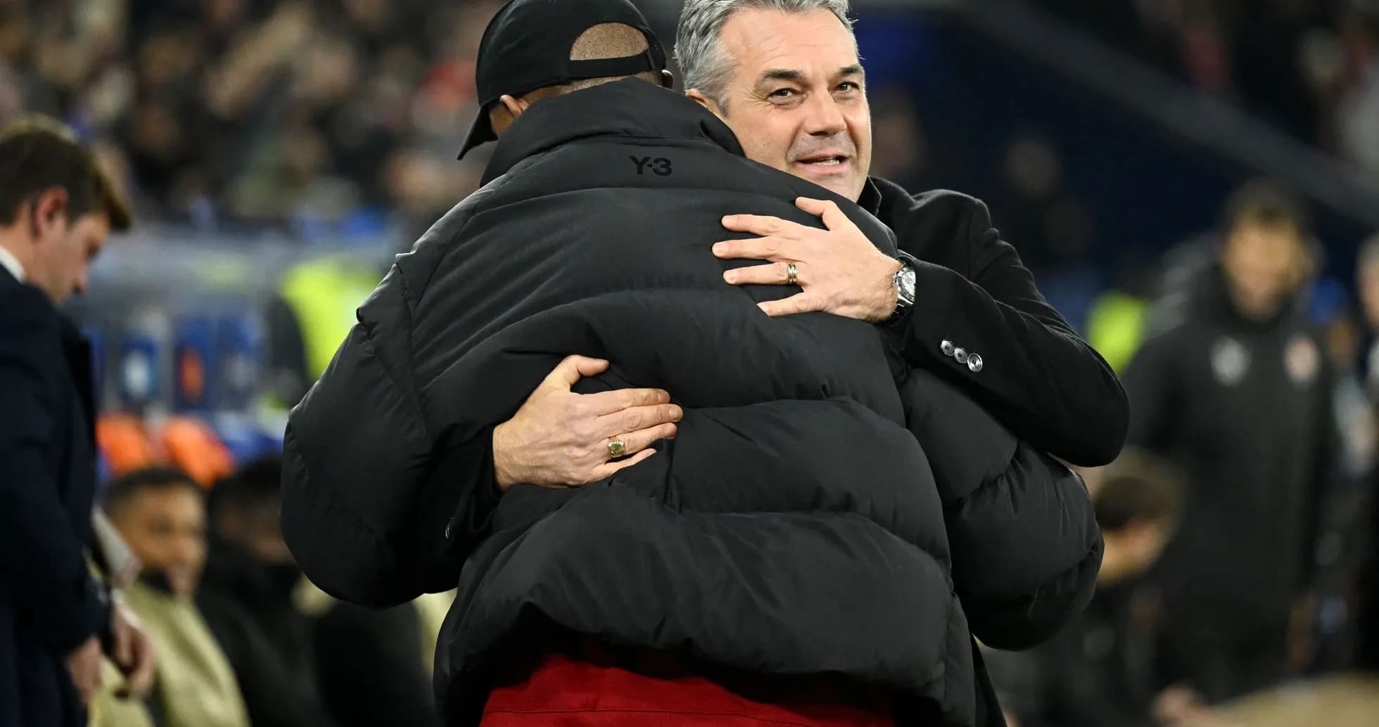 Two coaches embracing on the sidelines after match Two coaches embracing on the sidelines after match