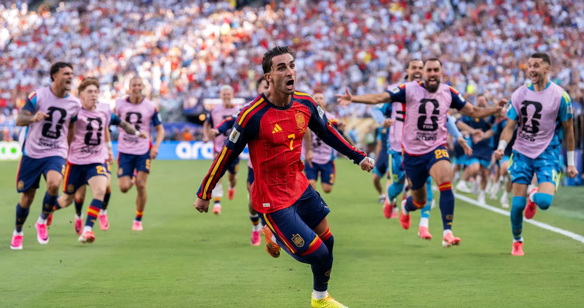 Spanish player celebrating goal with teammates during match Spanish player celebrating goal with teammates during match