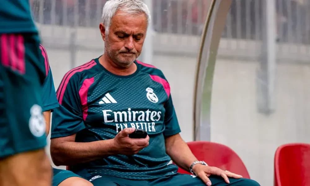 Manager sitting on bench checking phone during match Manager sitting on bench checking phone during match