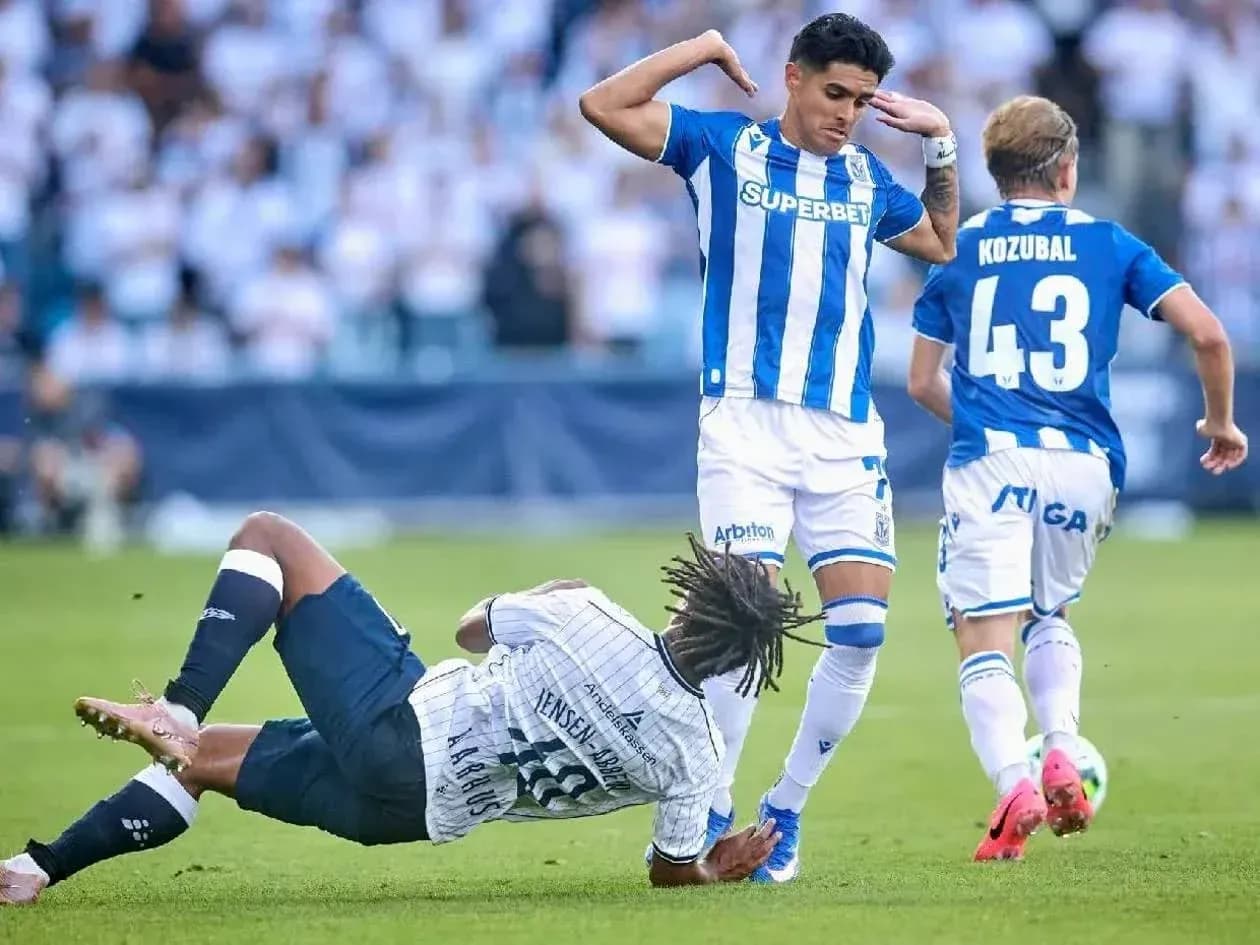 Lech Poznan player evading Aarhus defender Lech Poznan player evading Aarhus defender