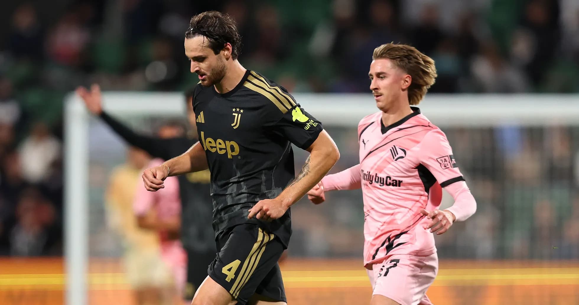 Juventus player running with opponent in pursuit Juventus player running with opponent in pursuit