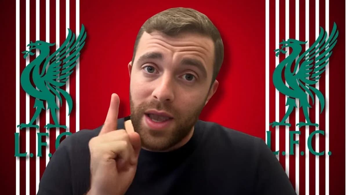 Person gesturing with finger in front of Liverpool FC logo Person gesturing with finger in front of Liverpool FC logo