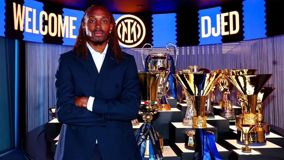 Player posing in front of trophies at event Player posing in front of trophies at event
