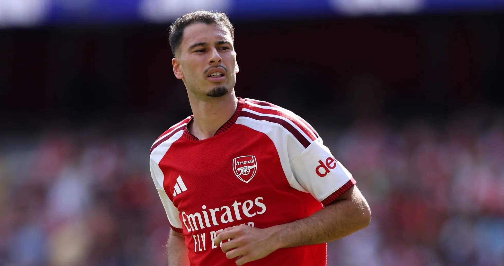 Arsenal player running on the pitch during match Arsenal player running on the pitch during match