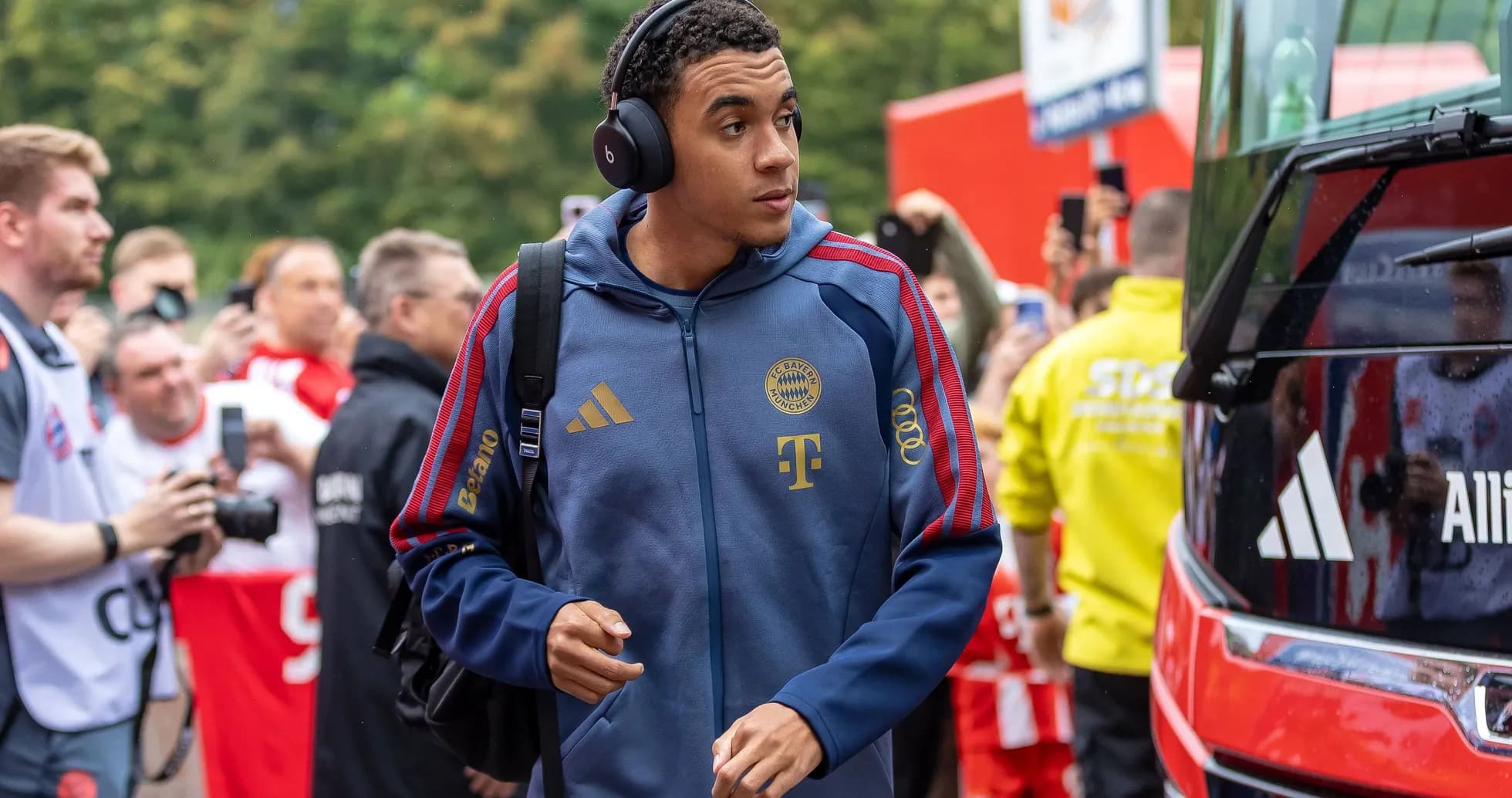 Player arriving at stadium wearing headphones and team jacket Player arriving at stadium wearing headphones and team jacket