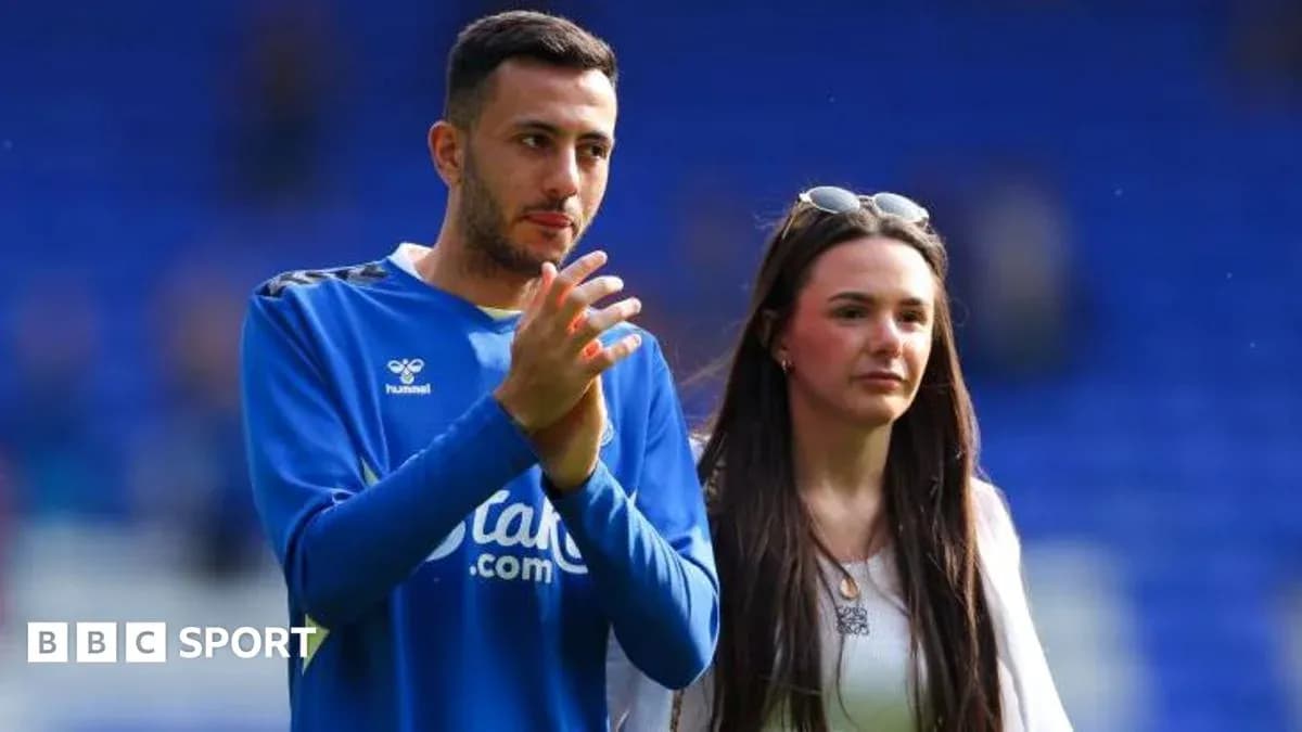 Football player and companion on the pitch Football player and companion on the pitch