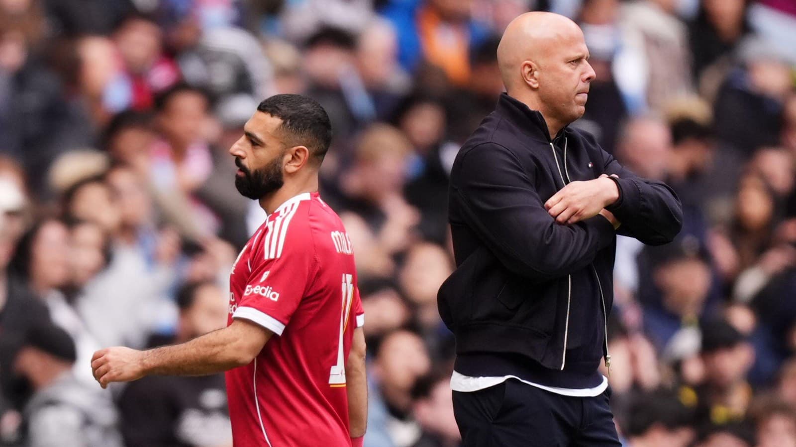 Player walking past coach during match on sidelines Player walking past coach during match on sidelines