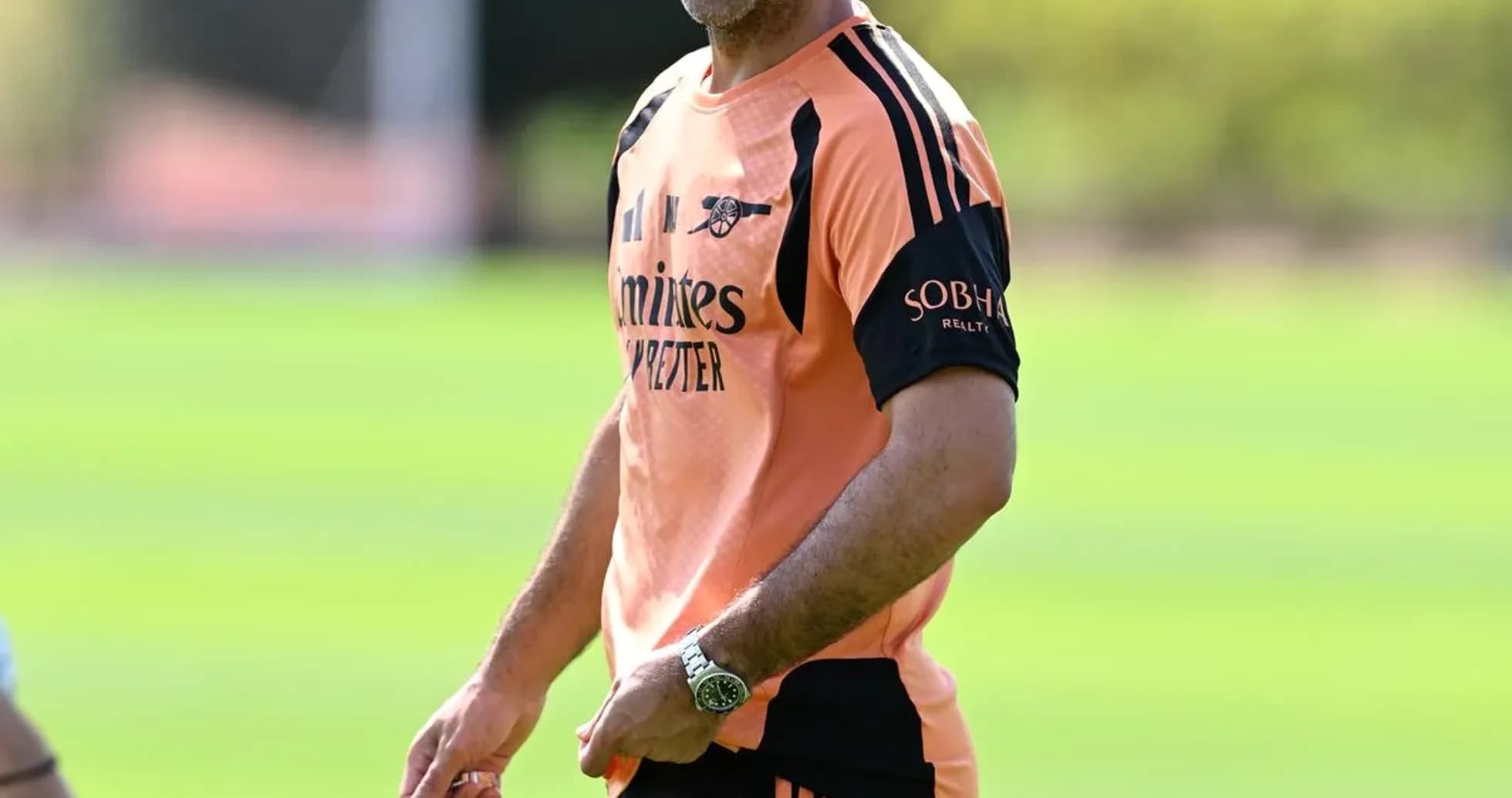Coach smiling during training session on pitch Coach smiling during training session on pitch